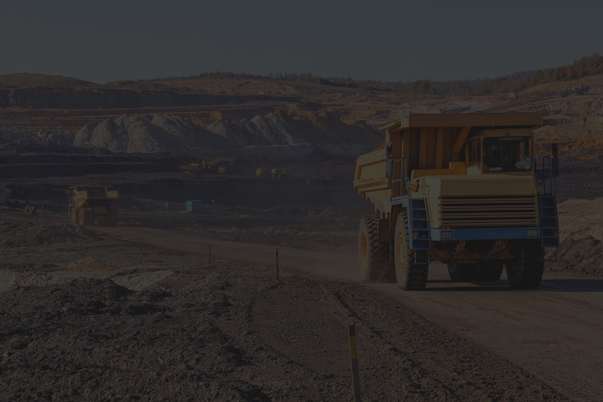 Mine pit at night lit by processing plant floodlights